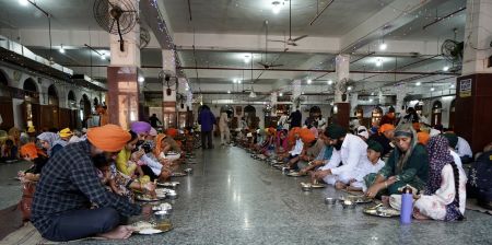 Volunteers serving food at the Golden Temple langar hall, Amritsar.