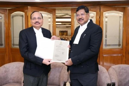 Justice Surya Kant and Justice Gavai holding his appointment notification as Chief Justice of India.