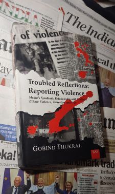 Gobind Book cover of Troubled Reflections: Reporting Violence by journalist Gobind ThukralThukral Book