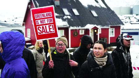 Protesters holding “Greenland is not for sale” placards