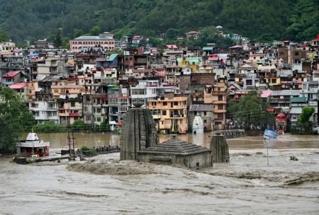 A temple partially submerged as floodwaters inundate a town in Himachal Pradesh during heavy monsoon rains.