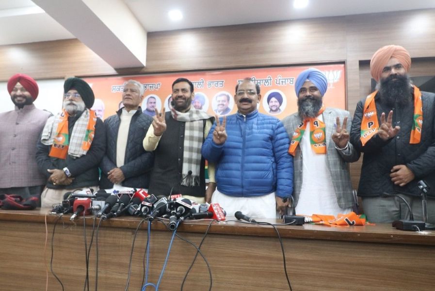 Senior BJP leaders and new entrants pose during a press conference at the Punjab BJP office in Chandigarh.