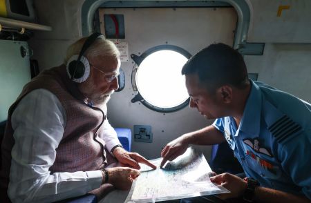 Prime Minister Narendra Modi reviewing flood damage in Himachal Pradesh during an aerial visit.