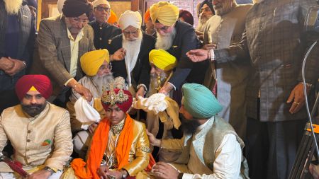 Ministers and attendees seated around a ceremonial participant