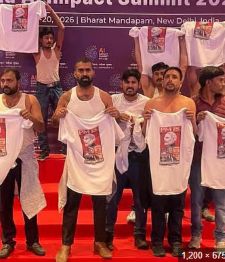 Group of men staging a shirtless protest onstage at an AI summit