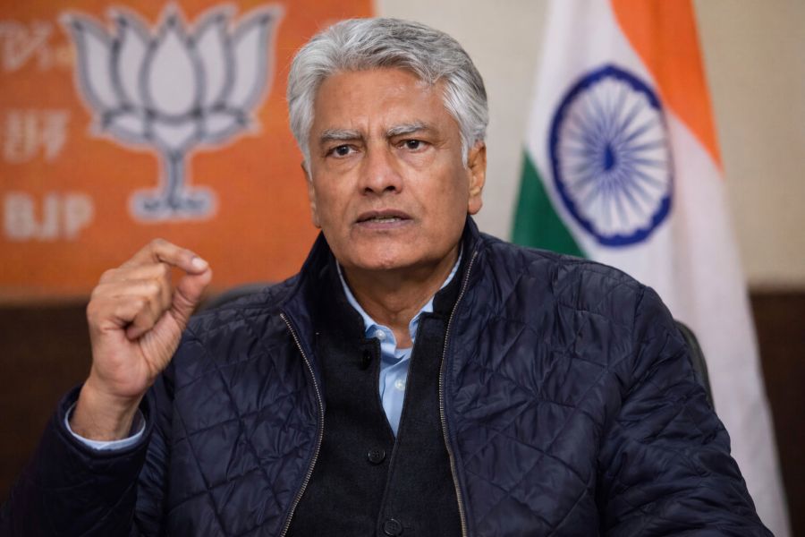 Sunil Jakhar, President of BJP Punjab, speaking during an interview, gesturing while seated against a BJP backdrop and the Indian national flag