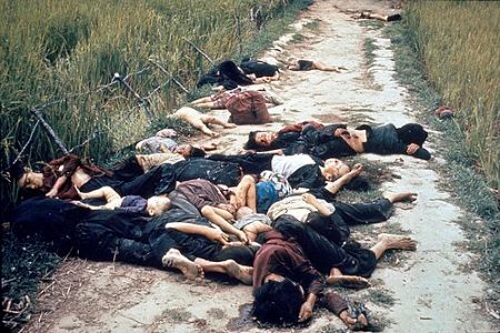 Historical photo of the victims of the My Lai Massacre in a dirt road.